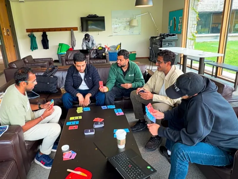 Friends gathered around the table playing the handmade UNICORN prototype